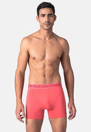 Bright coral boxer briefs with a pink branded elastic waistband, smooth texture, fitted design highlighting shape, and subtle stitching details.
