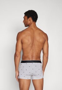 Men's gray boxer shorts made of soft fabric, featuring a black waistband with a subtle pattern of small logos throughout.