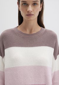 Knit pullover featuring alternating stripes of light pink, white, and lavender. Ribbed crew neck and textured fabric.