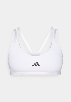 Hvit sports-bh med tynne stropper, med en svart Adidas-logo i midten. Glatt stoff og en tettsittende passform designet for aktiv bruk.