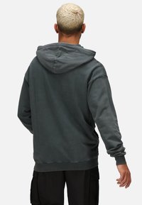 Dark gray hoodie with a drawstring hood, ribbed cuffs, and hem; made of soft fabric with a slightly worn texture. No visible graphics.