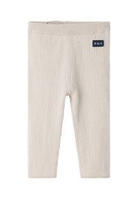 Lichtbeige geribde legging met een zachte textuur, voorzien van een elastische tailleband en een klein marineblauw logo op de bovenste linkerzijde.