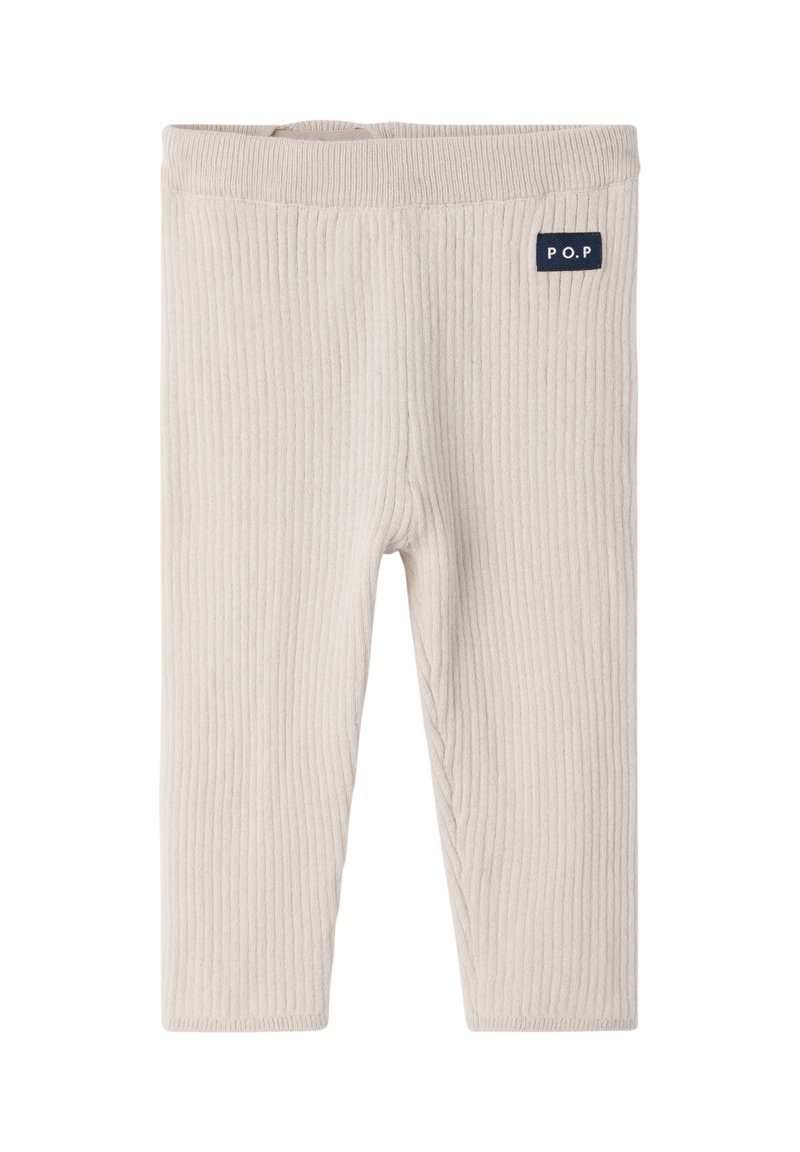 Lichtbeige geribde legging met een zachte textuur, voorzien van een elastische tailleband en een klein marineblauw logo op de bovenste linkerzijde.