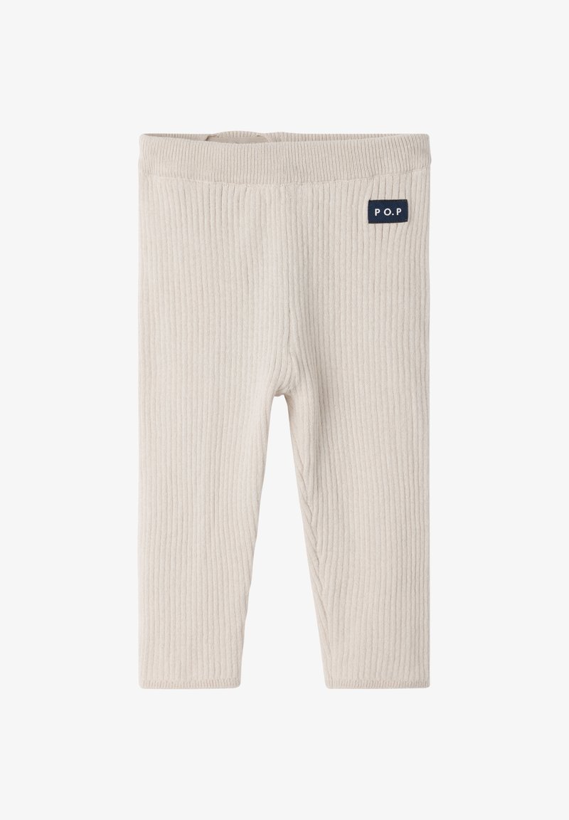 Lichtbeige geribde legging met een zachte textuur, voorzien van een elastische tailleband en een klein marineblauw logo op de bovenste linkerzijde.
