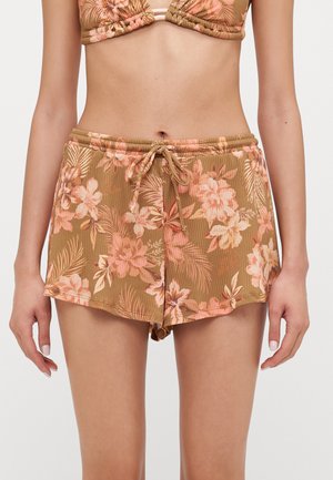 Brown floral swim shorts with a ribbed texture, featuring pink flowers and green leaves, and an elastic waistband with a drawstring.