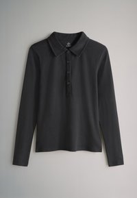 Black long-sleeve polo shirt with a collared neck, five-button placket, ribbed texture, and side vents for ease of movement.