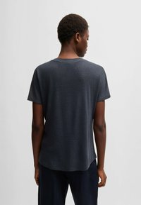Dark gray cotton t-shirt with short sleeves, relaxed fit, rounded neckline, and a straight hem, viewed from the back.