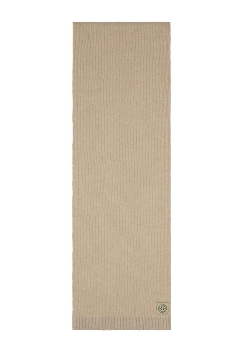 Bufanda de punto beige confeccionada en una tela suave. Presenta un pequeño parche con el logo y un borde texturizado ligeramente más grueso. Forma rectangular y larga.
