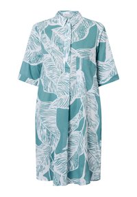 Ein Hemdkleid aus teal Baumwolle, mit einem weißen Blättermuster, kurzen Ärmeln, einer durchgehenden Knopfleiste und einer einzelnen Brusttasche.