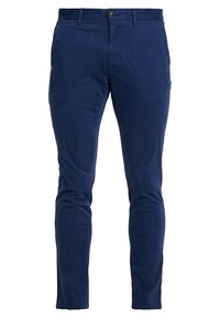 Slim-fit marinblå byxor för män med knapp- och dragkedjestängning, bälteshem, och sidofickor, visade på en vit bakgrund.