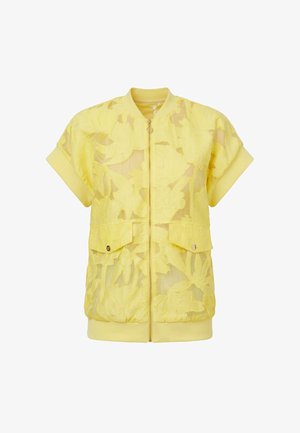 Giacca bomber gialla a maniche corte con sovrapposizione in pizzo floreale, zip frontale, due tasche con pattina e colletto e orlo a coste.