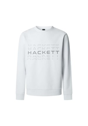 Valkoinen pitkähihaisa collegepaita, jossa rintaosassa on kerroksittain harmaalla tekstillä painettuna "HACKETT."