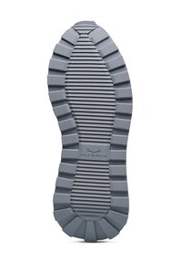 Gray rubber shoe sole with a ridged texture, featuring a central logo. The design has a wide, rounded shape and distinctive grooves.