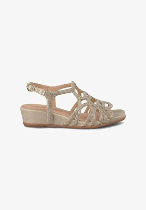 Sandales compensées beiges avec des accents de strass et un design ouvert. Comprend une boucle ajustable et une semelle intérieure texturée pour un confort supplémentaire.
