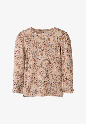 Haut à manches longues en tissu doux, avec un fond beige clair orné de motifs floraux multicolores en orange, jaune et gris.