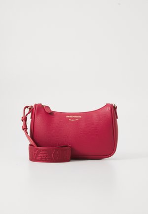 Red textured leather handbag with adjustable strap, gold zipper, and small gold logo text centered on front.