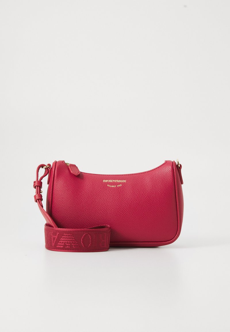 Red textured leather handbag with adjustable strap, gold zipper, and small gold logo text centered on front.