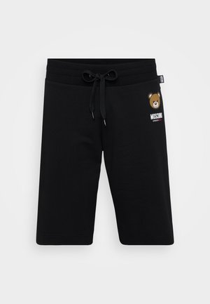 Black cotton shorts with an elastic waistband, drawstring detail, and a bear graphic with "Moschino" text on the front.