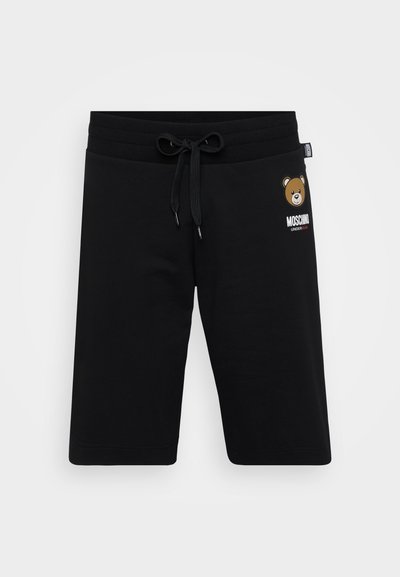 Calções pretos de algodão com um cós elástico, detalhe de cordão e um gráfico de um urso com o texto "Moschino" na parte da frente.