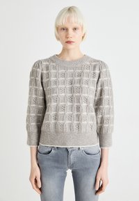 Pull en maille gris clair avec un motif texturé, encolure ronde et manches ballons. L'ourlet et les poignets côtelés rehaussent le design.