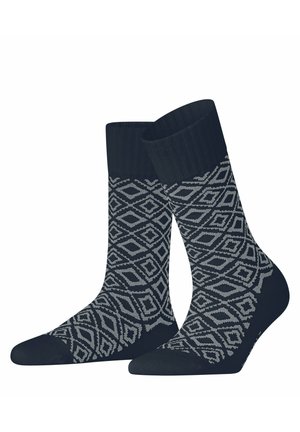 Paar schwarze Crew-Socken mit grauem geometrischem Diamantmuster, das den gesamten Stoff außer Bund und Zehenbereich bedeckt.