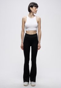 Urban Classics HIGH WAIST FLARED - Tajice-hlače - black