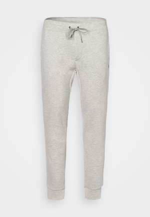 Pantalons de survêtement gris clair en tissu doux, dotés d'une taille élastique avec cordon de serrage et de poignets côtelés, conçus pour le confort.