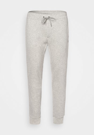 Pantalons de survêtement gris clair en tissu doux, dotés d'une taille élastique avec cordon de serrage et de poignets côtelés, conçus pour le confort.