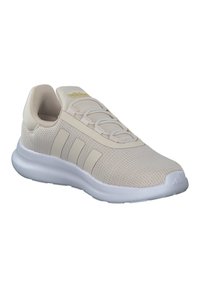 Chaussure de sport beige avec une tige en tricot texturé, semelle en caoutchouc blanche, et trois rayures blanches sur le côté, dotée d'un système de laçage élastique.