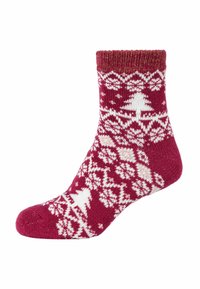 Rote und weiße gemusterte Socke mit einem Fair-Isle-Design, das Schneeflocken und Weihnachtsbäume darstellt, aus gestricktem Stoff mit einem gerippten Bündchen.