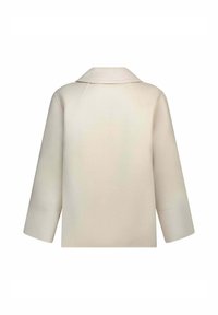 Cappotto in lana beige con colletto, vestibilità oversize e maniche ampie. Texture morbida con una finitura liscia e cuciture nascoste sul retro.