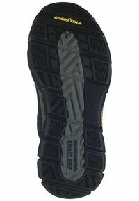 Suela de zapato de goma negra con patrones texturizados, acentos grises, marca "GOODYEAR" y detalle "SKECHERS STEADY GRIP" para tracción.