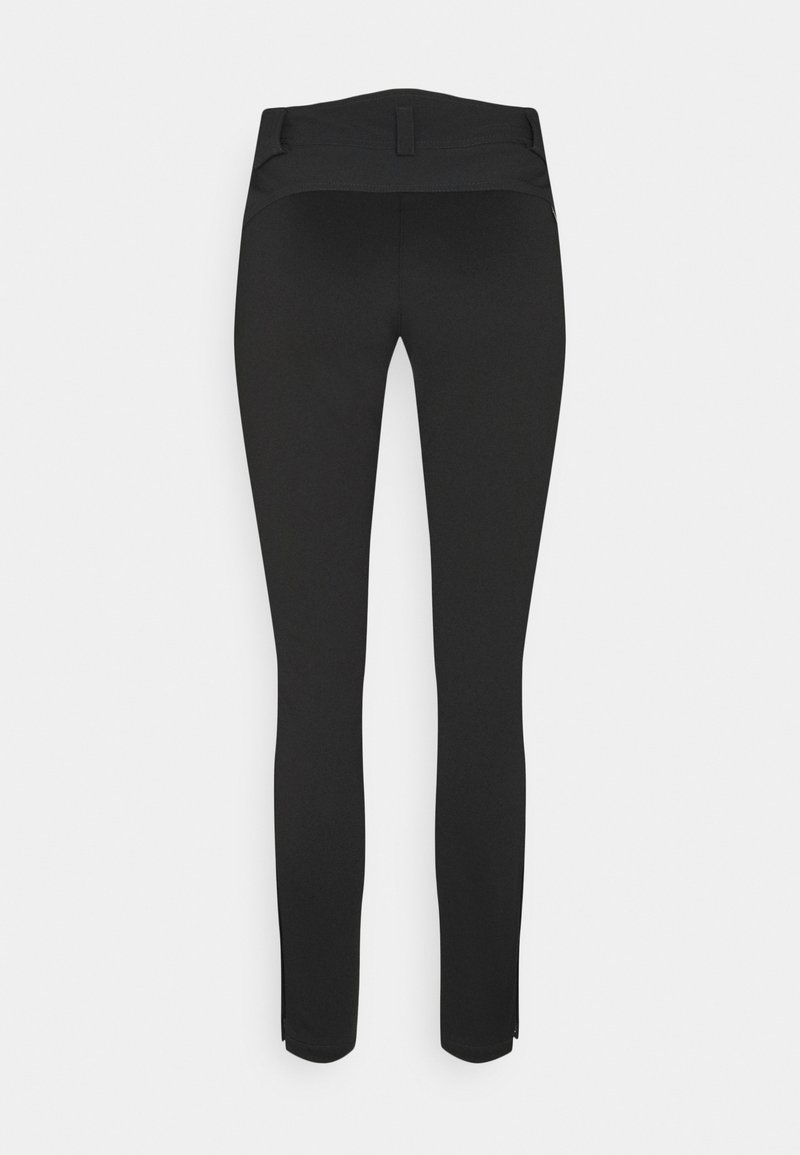 Schwarze dehnbare Leggings mit glatter Textur, figurbetontem Design und elastischem Bund. Mit kleinen Reißverschlüssen an den Knöcheln.