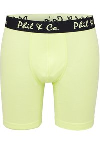 Boxers de color amarillo neón hechos de una tela suave, con una cinturilla elástica negra que presenta el logo blanco "Phil & Co.". Textura suave, diseño ajustado.