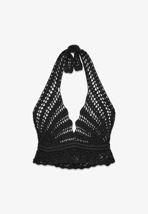 Top dos nu noir en crochet avec ourlet festonné et motif ajouré, noué au cou avec un nœud.