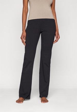 Black, stretch fabric pants with a straight leg design, featuring a smooth waistband and no visible pockets or patterns.