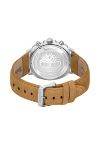 Hodinky Timberland so štrasovým puzdrom a svetlo hnedým semišovým remienkom. Obsahujú okrúhlu chrbtovú časť so stromovým logom a rôznymi hardvérovými akcentmi.