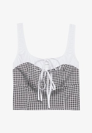 Črno-bele šahovnice zrezane majice z teksturiranim belim zgornjim delom, kvadratnim izrezom in nastavljivim trakom na sredini. Ima široke naramnice.