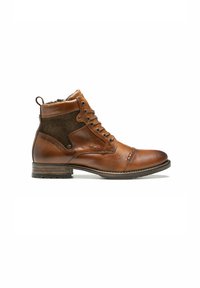 Bottines en cuir brun avec des accents en tissu, à lacets sur le devant, bout rond et semelle texturée. Dotées d'une petite boucle à l'arrière pour un enfilage facile.