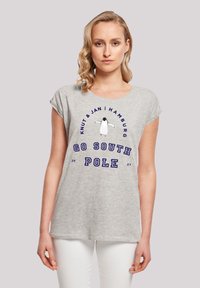 Graues T-Shirt mit kurzen Ärmeln, das ein Pinguin-Design und den Text "GEHE ZUR SÜDPOL" in Blau zeigt. Weicher Stoff mit lockerer Passform.