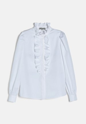 White long-sleeve blouse with ruffled collar and front placket, buttoned cuffs, and vertical ruffle detail down the center.