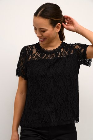 Black lace top with short sleeves and scalloped neckline, featuring floral patterns and a textured finish over a solid base.