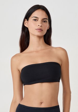 Top bandeau negro sin tirantes hecho de una tela suave con una banda elástica. Diseño simple, sin patrones ni detalles de hardware visibles.