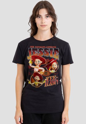 Young woman wearing a black t-shirt with three cartoon images of Jessie the yodeling cowgirl from Toy Story and text "Yee-haw!"