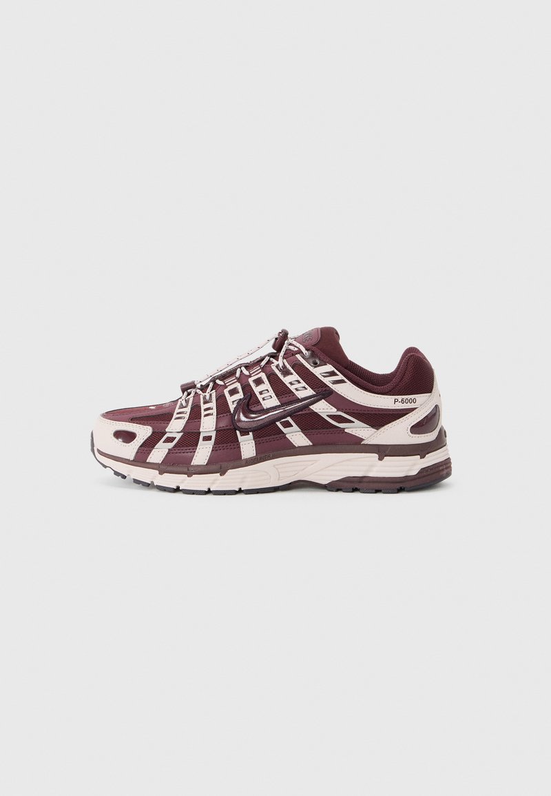 Maroon and cream athletic shoe with a mesh upper, supportive overlays, padded collar, and textured rubber outsole. Reflective accents present.