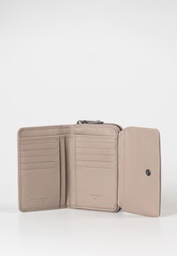 Beige leather wallet features a zip closure, six card slots, two compartments, and embossed branding. Smooth texture and minimal design.