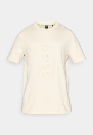 T-shirt en coton couleur crème avec des manches courtes et un logo texturé « BOSS » centré sur le devant. Encolure arrondie, coupe décontractée.