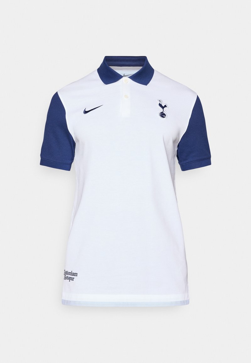 Polo shirt blanche avec des manches bleu marine, fabriquée en coton. Présente un col, une fermeture à boutons et le logo de Tottenham Hotspur sur la poitrine.