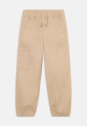 Beige cargo nadrág elasztikus derékkal, húzózsinórral és oldalzsebekkel. Bokáig érő szegélyekkel és egy kis logóval a derékon.