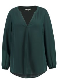 Blouse verte à manches longues avec un col en V. Conçue en tissu lisse avec un ourlet légèrement arrondi et des manches froncées aux poignets.